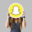 Woman showing a Snapchat icon