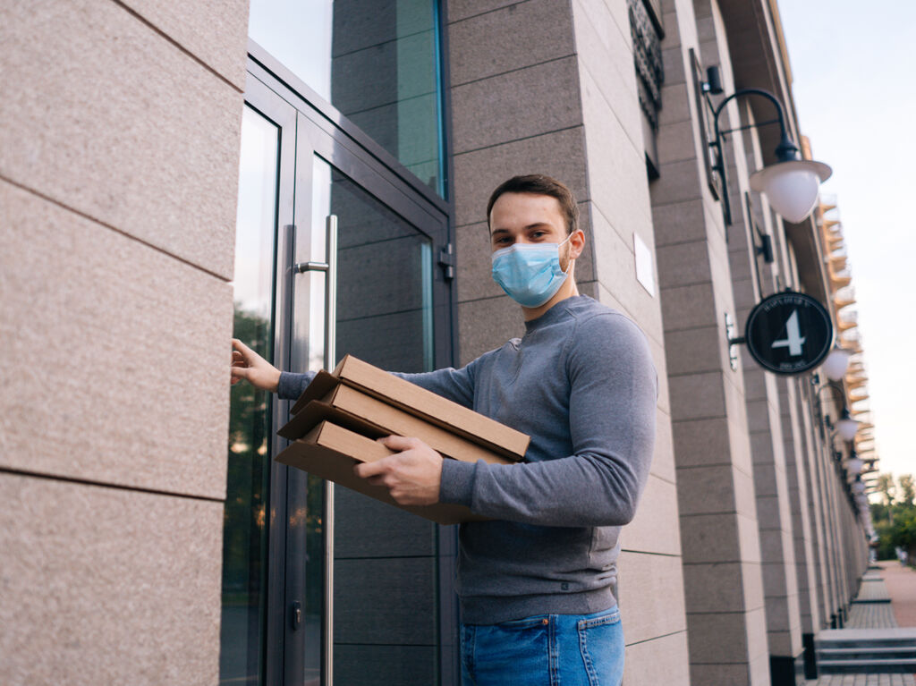 delivery-man-wearing-medical-mask-ringing-door-delivery-carton-boxes-with-hot-pizza-copy
