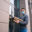 feature-delivery-man-wearing-medical-mask-ringing-door-delivery-carton-boxes-with-hot-pizza-copy.jpg