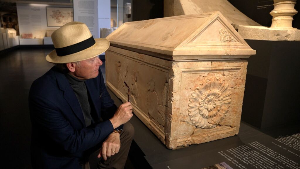 With the sarcophagus of King Herod the Great in the Israel Museum, Jerusalem