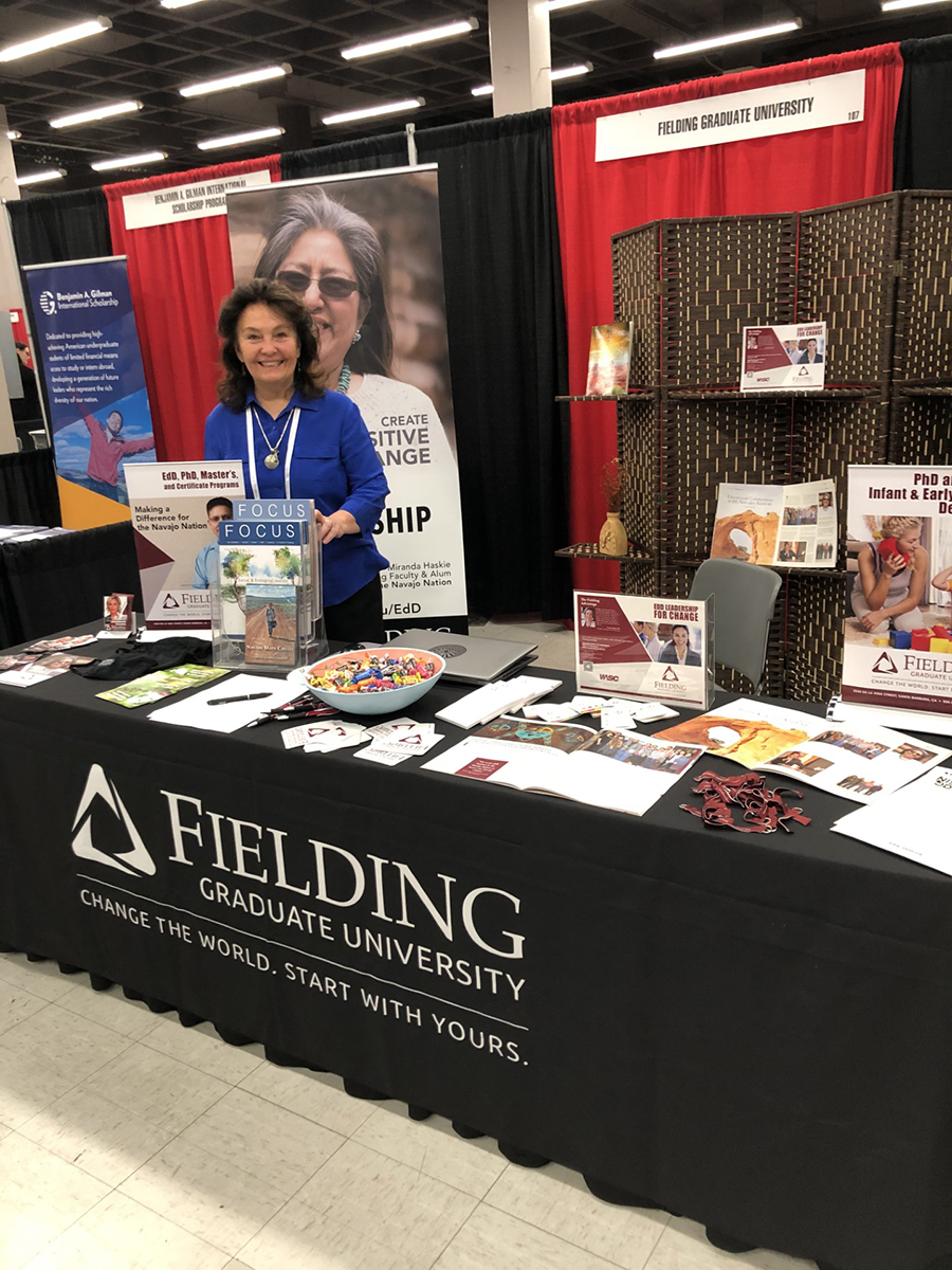 Dr. Barbara Mink at the Fielding Booth at NIEA Convention 2023 in Albuquerque, NM.