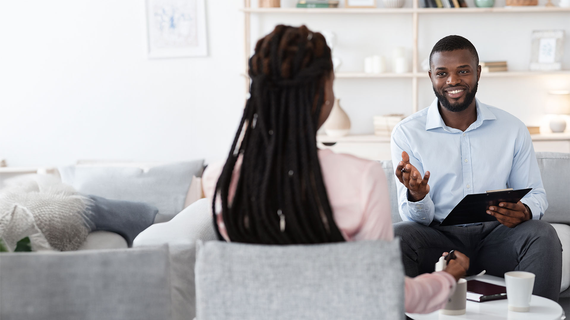 Black psychologist talking to client.