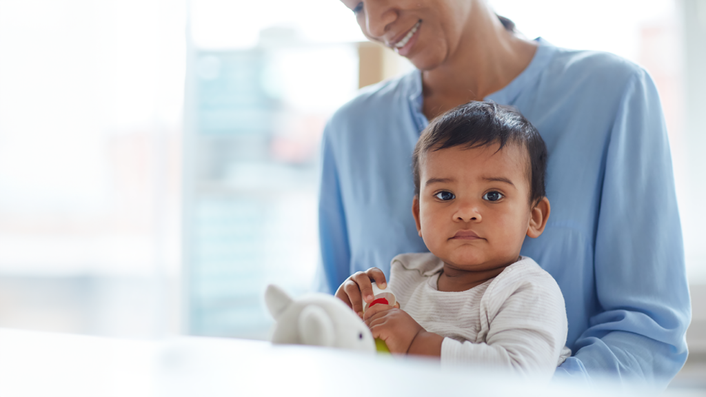 mother looks down adoringly at her child.